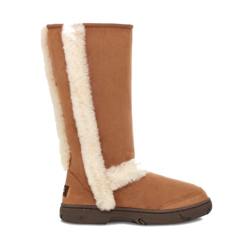 A brown suede and faux fur-lined knee-high boot with a flat sole. The boot has a side opening, exposing the luxurious sheepskin lining, reminiscent of the UGG SUNBURST TALL CHESTNUT - WOMENS collection by Ugg.