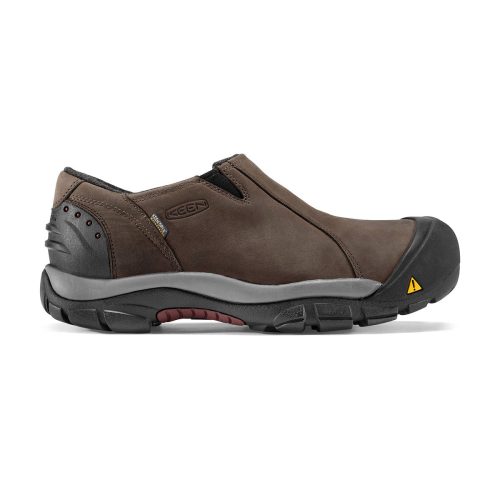 A brown, slip-on waterproof shoe with a black rubber sole, reinforced toe, and a small triangular yellow symbol near the toe. Perfect for winter-ready construction, it features KEEN.Warm insulation to keep your feet comfortable. The Keen KEEN BRIXEN LOW WP MADDER BROWN - MENS is ideal for these conditions.