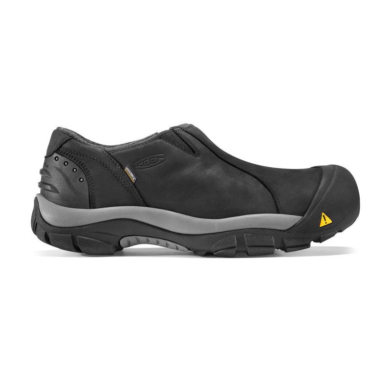 The KEEN BRIXEN LOW WP BLACK - MENS from Keen is a black slip-on work shoe with a rugged rubber sole and protective toe, featuring KEEN.Warm insulation for added comfort. The shoe showcases a yellow triangle logo on the front, branding on the side, and wool felt lining for extra warmth.