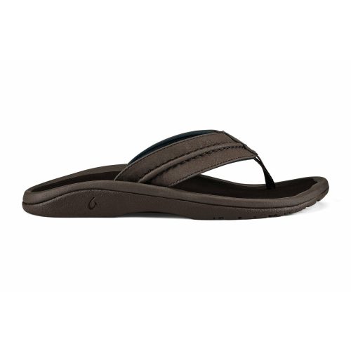 A water-resistant men’s sandal, the OLUKAI HOKUA DARK WOOD - MENS by Olukai, features a brown flip-flop design, cushioned sole, and thong-style strap. It is shown in side profile against a white background. The anatomically correct EVA midsole ensures maximum comfort with every step.