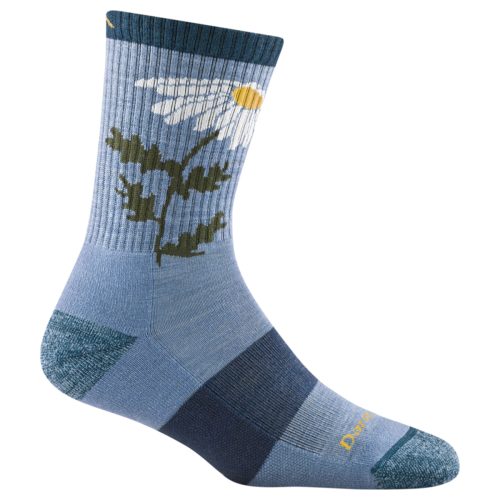 The Darn Tough DARN TOUGH QUEEN BEE MICRO CREW HIKER VAPOR in blue, showcasing a large white daisy with a yellow center and green leaves. Made from soft merino wool, this sock includes ribbed detailing at the top and contrasting toe and heel sections, perfect for comfort and style.