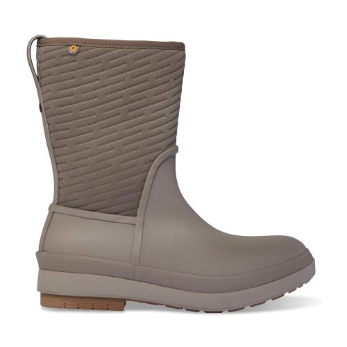 A side view of a single BOGS CRANDALL II MID ZIP FOSSIL - WOMENS boot by Bogs with a taupe lower section and a quilted upper section. The boot features winter insulation, a pull tab on the back, and a textured sole for added grip.