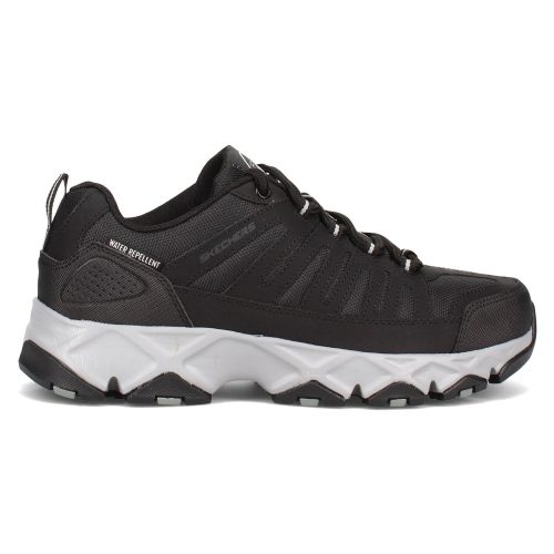 A single black and white OLUKAI PEHUEA BRIGHT WHITE/BRIGHT WHITE women's sports shoe with rugged sole design.