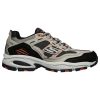 A grey, black, and orange SKECHERS VIGOR 2 NANOBET GRAY/ORANGE - MENS athletic shoe with a thick sole, mesh detailing, shock-absorbing midsole, and the letter "S" on the side by Skechers.