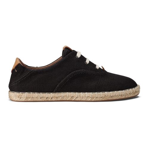 A black canvas sneaker with white laces and a woven sole edge, featuring brown accents on the back and tongue, resembles the Olukai OLUKAI KAULA PA'A LI BLACK - WOMENS espadrille with its casual yet refined style.