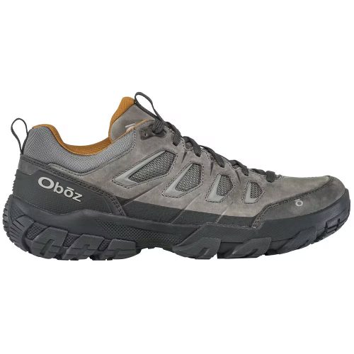 A gray and black OBOZ SAWTOOTH X LOW HAZY GRAY - MENS with a thick sole and sturdy design, featuring the brand name "Oboz" on the side and heel, perfect for technical trails with its reliable traction.