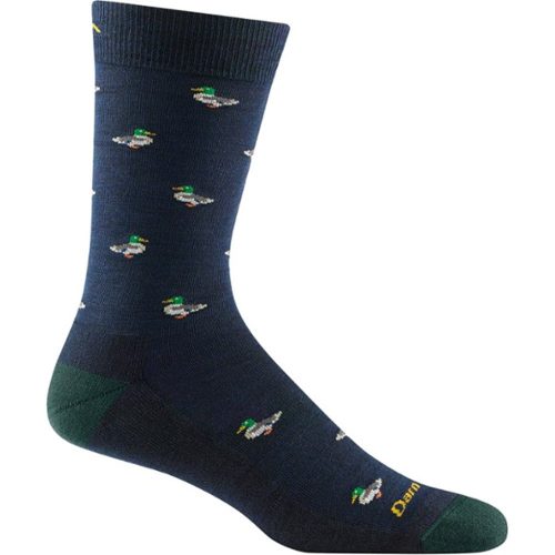 A dark blue men's lifestyle sock with small white and green duck illustrations, green toe and heel accents, yellow writing near the toe, and made from lightweight merino wool for comfort. The Darn Tough DARN TOUGH DUCK DUCK MOOSE CREW SOCKS ECLIPSE comes with an unconditional lifetime guarantee.