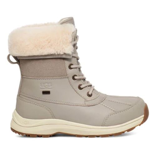 A UGG ADIRONDACK BOOT III GOAT - WOMENS with a fluffy, cream-colored lining, lace-up front, and a ribbed, tan sole featuring extra warming insulation for those chilly days.