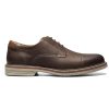 Here is the revised sentence using the given product data:  A single Florsheim Norwalk Cap Toe Oxford Crazy Horse Brown men's shoe, crafted from dark brown leather with white stitching and featuring a tan sole and low heel, shown in a side profile view.