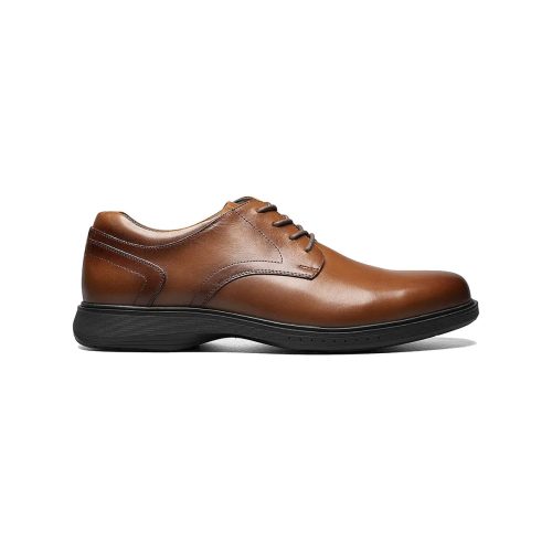 A Nunn Bush NUNN BUSH KORE PRO PLAIN TOE COGNAC - MENS with black outsole and slip-resistant sole, side view.