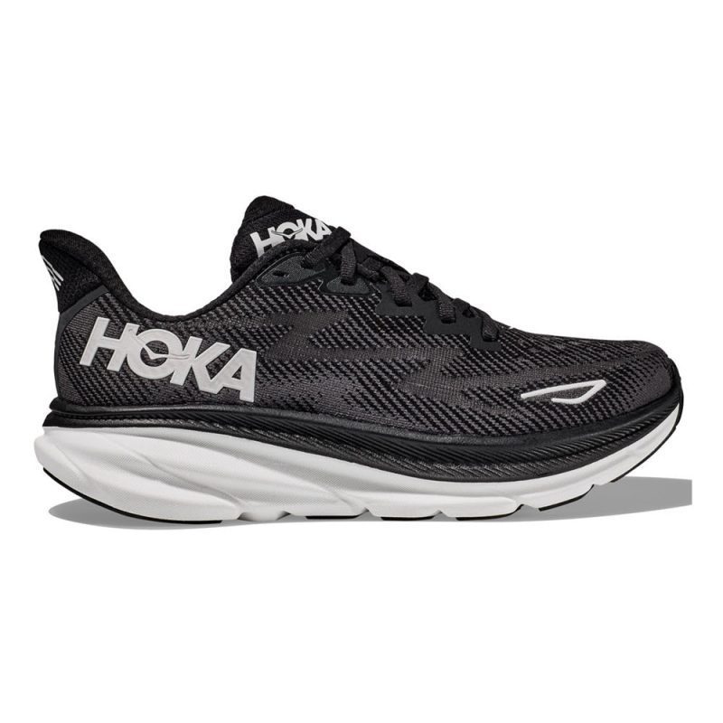 A black HOKA CLIFTON 9 BLACK/WHITE - MENS running shoe with a white Hoka logo on the side and a thick, responsive new foam sole for enhanced comfort.