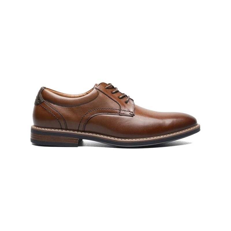 Brown leather dress shoe with black laces and a dark brown sole, featuring a stacked heel and modern silhouette, displayed in a side view. Product Name: NUNN BUSH CENTRO FLEX PLAIN TOE OXFORD COGNAC - MENS Brand Name: Nunn Bush