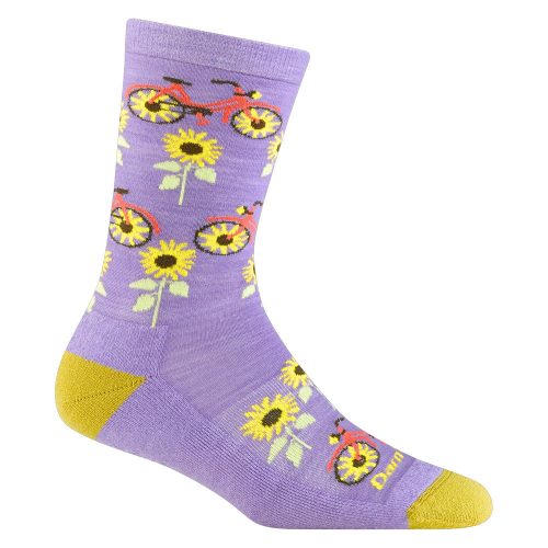 Introducing the Darn Tough DARN TOUGH SUN PEDAL CREW SOCKS LAVENDER - WOMENS—a purple sock with yellow heels and toes, featuring a vibrant pattern of red bicycles and yellow sunflowers. Perfect for cycling adventures along rail trails.