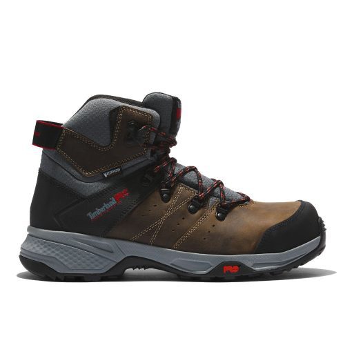 A brown and black hiking boot with a rugged sole, red accents, and "Timberland" written on the side, featuring Anti-Fatigue Technology for all-day comfort is the TIMBERLAND CT SWITCHBACK WATERPROOF TURKISH COFFEE - MENS.