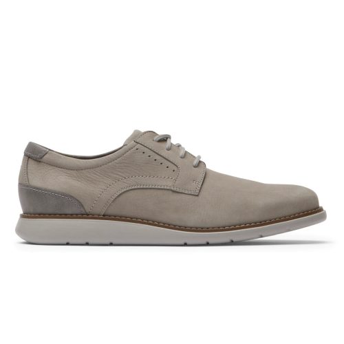 A side view of a beige lace-up ROCKPORT TOTAL MOTION CRAFT PLAIN TOE TAUPE - MENS with an IMEVA sole, designed with leather uppers featuring a smooth texture and gray accents on the heel from Rockport.