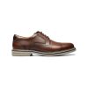 The Florsheim FLORSHEIM NORWALK PLAIN TOE CRAZY HORSE - MENS is a brown leather lace-up dress shoe with a round toe and beige rubber sole, featuring a cushioned footbed for all-day comfort.