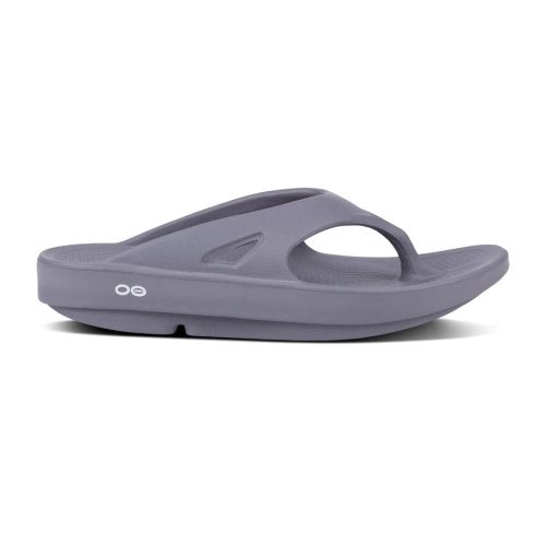 A side view of a single gray OOFOS OORIGINAL SLATE - MENS sandal with a thick OOfoam sole and a strap over the top featuring the "OO" logo, designed to reduce stress.