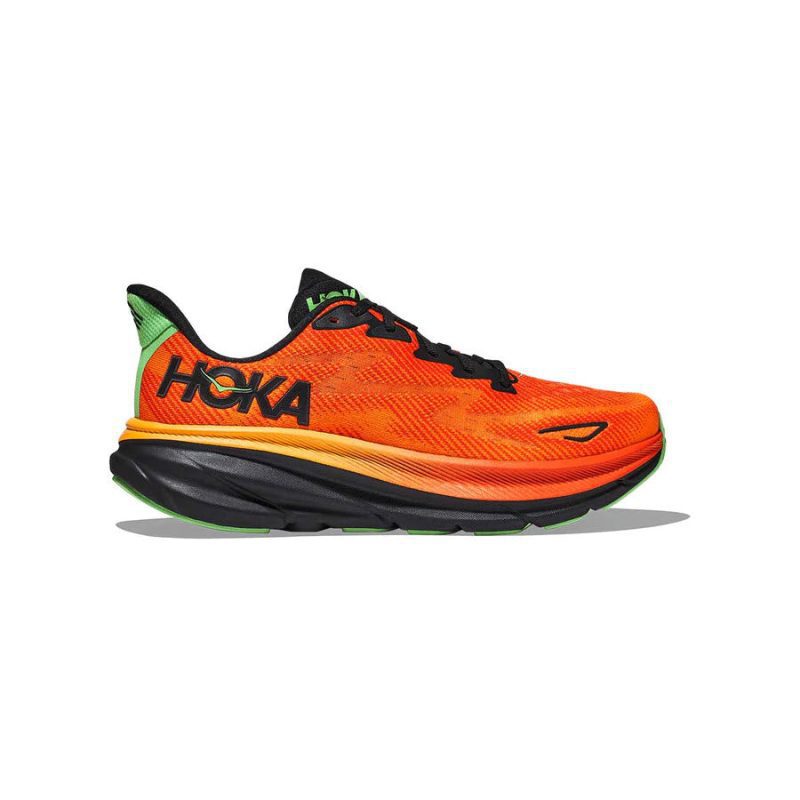 A bright orange HOKA CLIFTON 9 FLAME/VIBRANT ORANGE - MENS running shoe with black, green, and yellow accents, featuring a thick, cushioned sole with improved outsole design and the Hoka logo on the side.