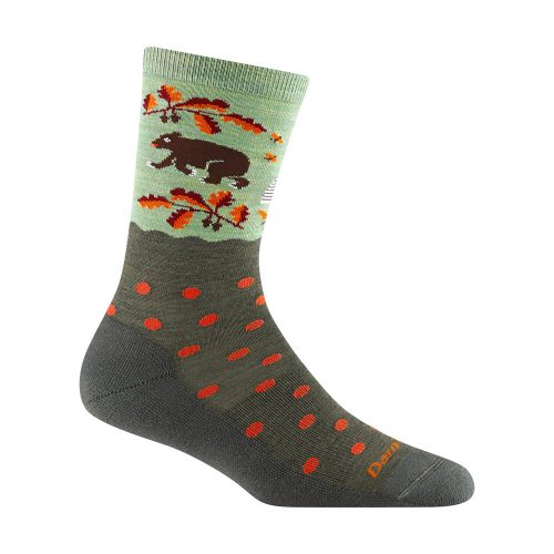 Green and gray Darn Tough WILDLIFE CREW SOCKS FOREST - WOMENS featuring a bear and trees pattern near the top, red polka dots on the lower half, and made from cozy Merino wool with a lifetime guarantee.