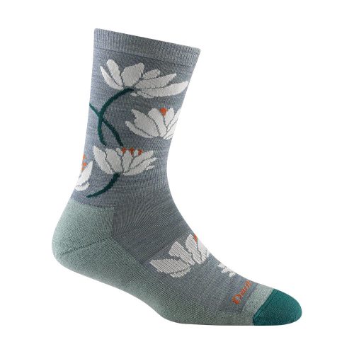 Darn Tough DARN TOUGH LILIES CREW SOCKS SEAFOAM - WOMENS with a white flower pattern, green heel, and toe accents. Made from Merino wool, this sock is odor resistant and stylish.