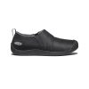 Side view of a black KEEN HOWSER II SLIPPER TRIPLE BLACK - MENS hybrid slip-on shoe with textured sole, cozy fleece lining, and a small loop strap at the heel, featuring the Keen logo near the back.