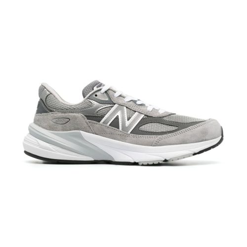 A gray New Balance NEW BALANCE 990 V6 GREY - WOMENS running shoe featuring a mesh and suede upper, lace-up closure, ENCAP midsole cushioning for comfort, and a durable rubber outsole.