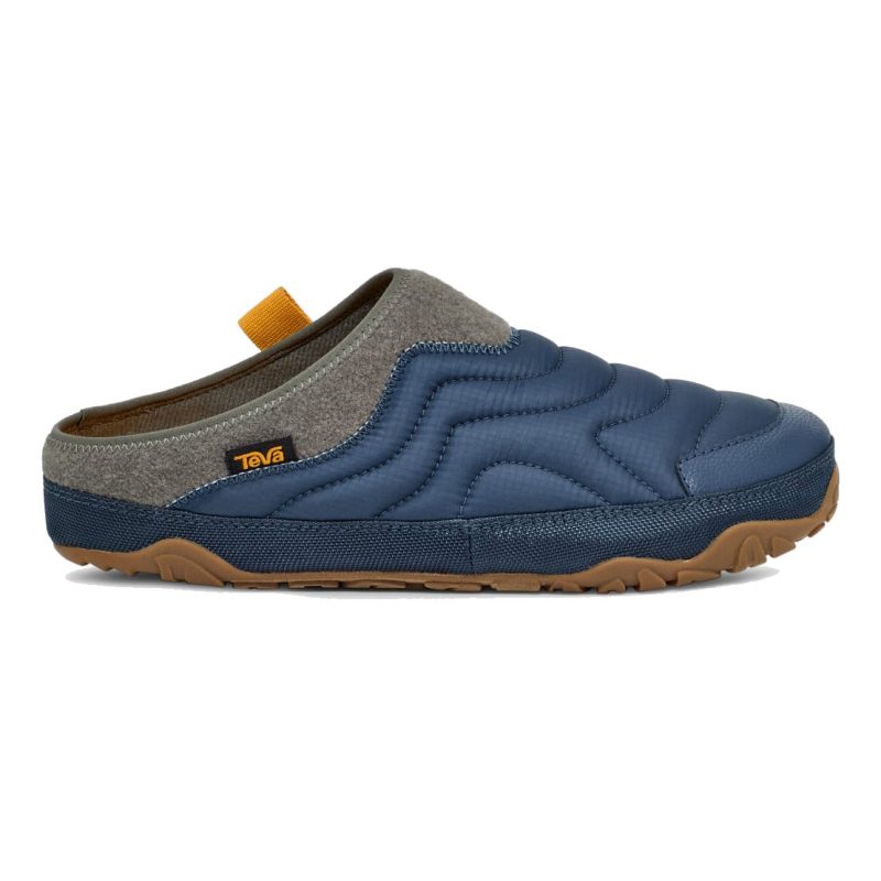 A blue, quilted next-level lounge slip-on shoe with brown sole and gray detailing, featuring the innovative ULTRA-COMF insole technology, a small yellow tab, and a "Teva" logo. Perfect for those seeking comfort and style, this TEVA REEMBER TERRAIN SLIP ON BLUE WING TEAL - MENS model adds a touch of luxury to your everyday wardrobe.