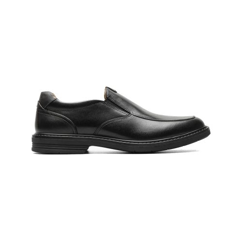 A black leather FLORSHEIM NORWALK MOC TOE SLIP ON BLACK - MENS with a thick sole, minimalist stitching, and a slightly rounded toe, featuring comfort technology for all-day wear. Viewed from the side against a white background.