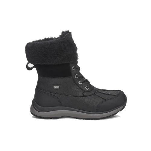 The UGG ADIRONDACK BOOT III BLACK/BLACK - WOMENS from Ugg features a black winter boot with a fur-lined cuff, lace-up closure, rugged sole, and small loop at the back. These waterproof boots also feature extra warming insulation for ultimate comfort.