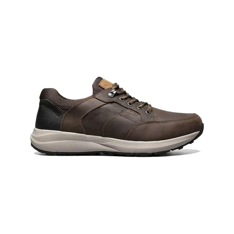 A Nunn Bush NUNN BUSH EXCURSION MOC TOE OXFORD CRAZY HORSE BROWN - MENS with a tan sole, dark brown laces, and metal eyelets. The shoe features black detailing near the heel and a cushioned sole for comfort, incorporating KORE technology for enhanced walking support.