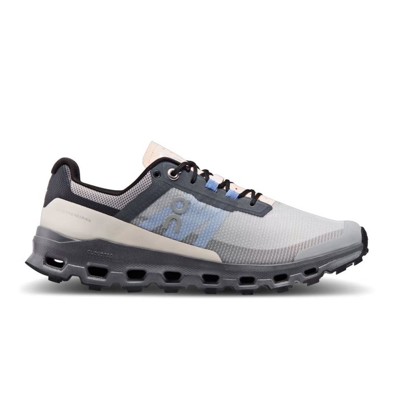 A gray and white lightweight trail running shoe with black laces, featuring a cushioned Helion super foam sole, mesh exterior, Missiongrip outsole, and On Running branding on the side. The product is called ON CLOUDVISTA ALLOY/BLACK - MENS.