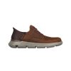 A Skechers Gervin Plain Toe Slip-In Brown men's shoe with a thick, grey sole featuring Skechers Air-Cooled Memory Foam, and textured details on the quarter panel, isolated on a white background.