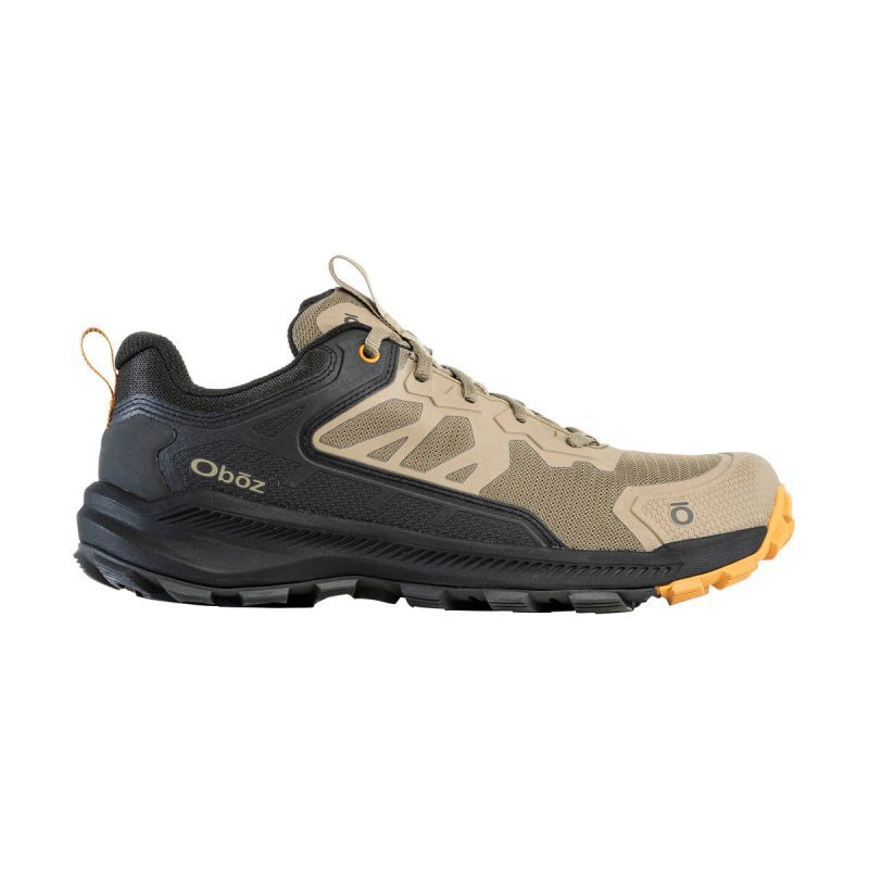 A single beige and black hiking shoe with the brand name "Oboz" on the side, featuring a rugged sole with multi-directional lugs and orange accents, specifically the OBOZ KATABATIC LOW THICKET - MENS.