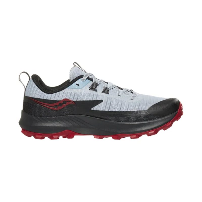 The SAUCONY PEREGRINE 13 VAPOR/POPPY - MENS is a light gray and black trail running shoe with red accents and a rugged red sole, viewed from the side. This versatile Saucony shoe effortlessly combines style with functionality for your athletic needs.