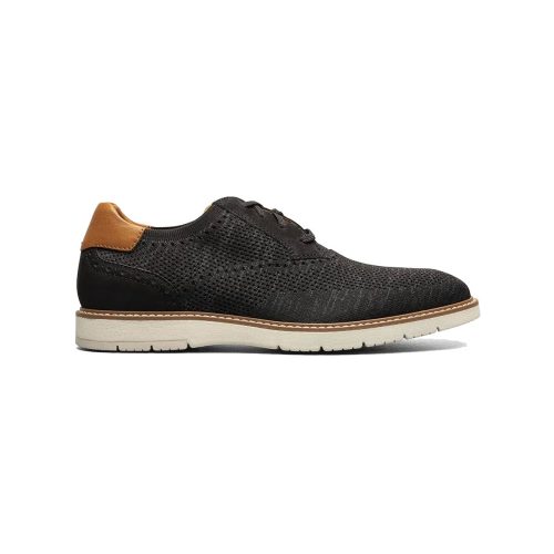 Side view of a black sporty FLORSHEIM VIBE KNIT PLAIN TOE OXFORD BLACK - MENS with a light brown leather accent on the heel, a white sole, and featuring the Comfortech footbed for enhanced comfort by Florsheim.