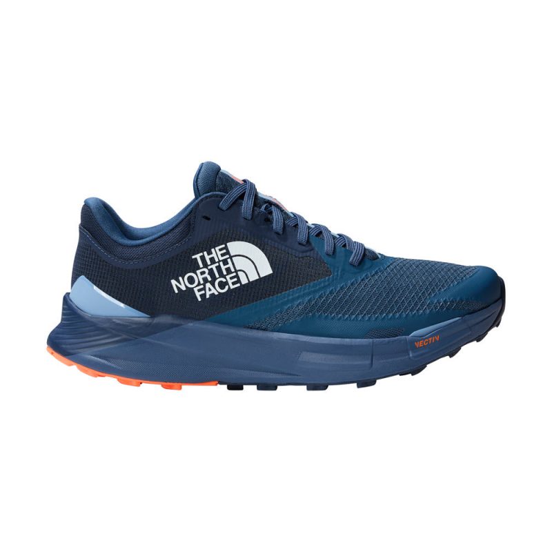 A blue and navy trail running shoe by North Face with the logo on the side, featuring an orange sole and highly cushioned VECTIV™ technology, ideal for ultra-distance trail running, is the NORTH FACE VECTIV ENDURIS 3 SHADY BLUE/SUMMIT NAVY - MENS.