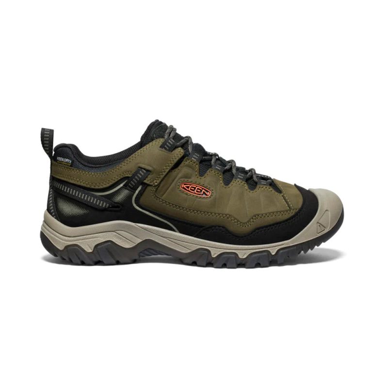 A dark green and black hiking shoe with a rugged sole, lace-up closure, and the brand name "Keen" displayed on the side. The KEEN TARGHEE IV WP DARK OLIVE/GOLD FLAME - MENS model boasts cushioning that resists compression, ensuring both comfort and durable construction for all your outdoor adventures.