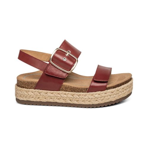 Aetrex AETREX VANIA RED - WOMENS is a red sandal with a chunky platform sole, woven rope detail, and two straps secured by a gold buckle, featuring memory foam cushioning for ultimate comfort.