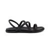 Side view of the Olukai OLUKAI TIARE STRAPPY BLACK - WOMENS sandal with buttery-soft leather straps and a flat sole on a white background.