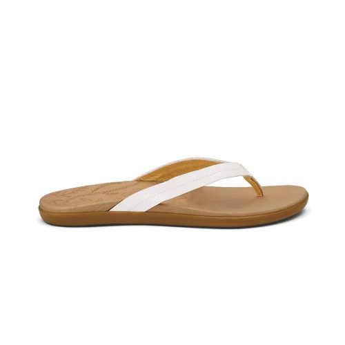 A side view of a tan OLUKAI HONU BRIGHT WHITE - WOMENS flip-flop with a white strap, a slight heel, and a comfortable leather footbed by Olukai.