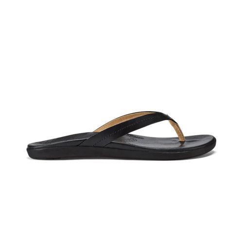 An Olukai OLUKAI HONU BLACK - WOMENS flip-flop sandal with a full-grain leather brown foot strap and flat rubber sole, shown in a side view against a white background.