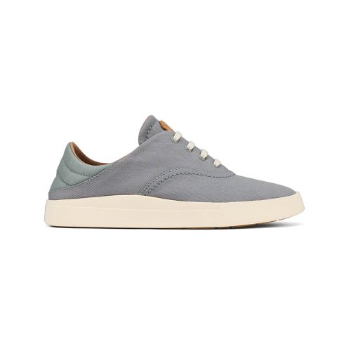 A side view of the Olukai OLUKAI KOHU MIST GREY - WOMENS, a minimalist casual grey sneaker with a light green accent on the heel, white laces, and a white rubber sole, designed for maximum comfort.