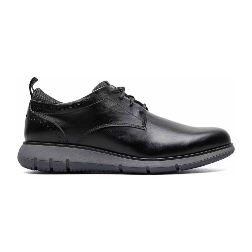 The NUNN BUSH STANCE PLAIN TOE OXFORD BLACK - MENS by Nunn Bush is a black leather lace-up shoe with perforated details near the ankle, featuring a thick gray rubber sole and an eco-conscious design.