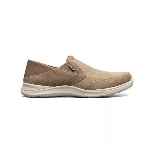 A Nunn Bush NUNN BUSH CONWAY EZ CANVAS MOC TOE SLIP ON STONE - MENS with a slightly elevated sole, featuring a minimalist design, light stitching accents, and an Ez in Ez out heel inspired by the Nunn Bush Conway.