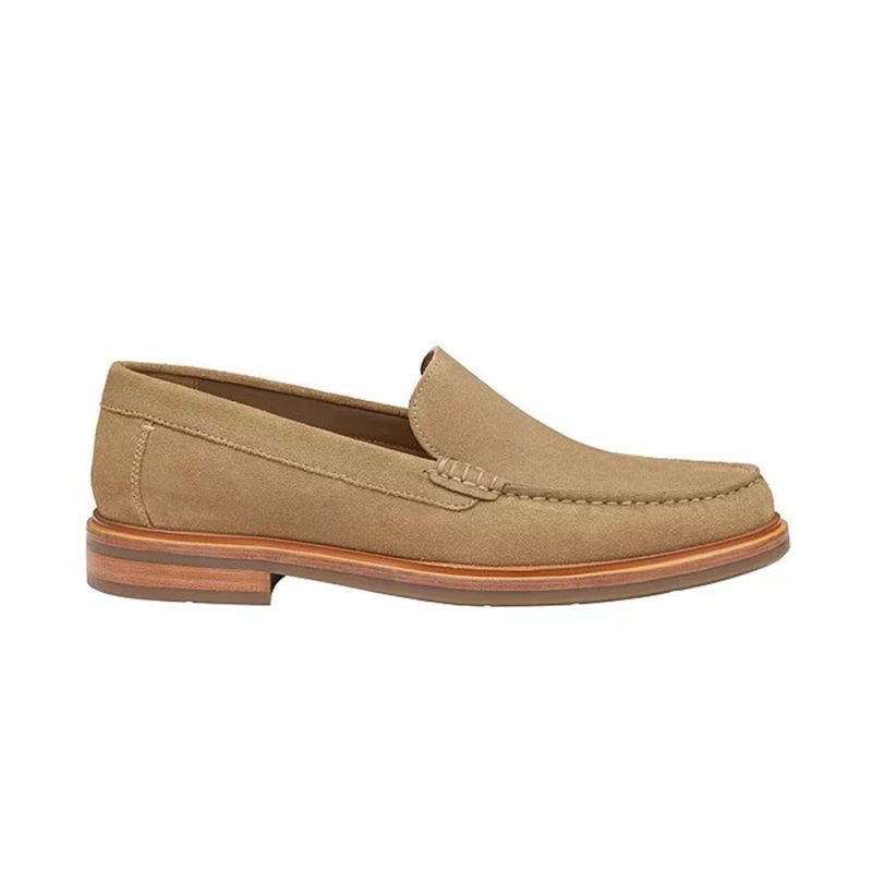 A tan suede loafer with a wooden sole and stitching detail on the upper, viewed from the side, featuring a TRUFOAM footbed for ultimate comfort. This classic JOHNSTON & MURPHY LYLES VENETIAN SLIP ON TAUPE SUEDE - MENS from Johnston & Murphy ensures style and durability.