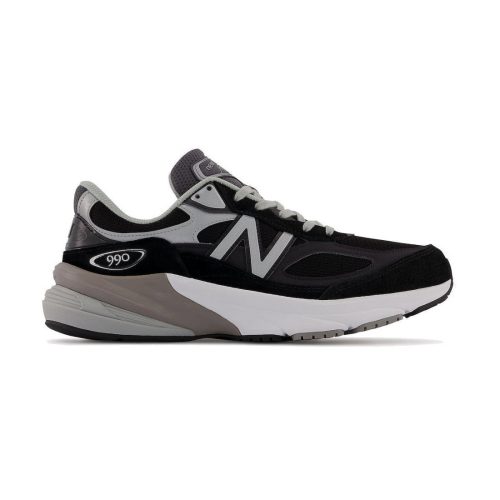 Side view of a New Balance NEW BALANCE 990V6 BLACK - WOMENS running shoe in black, gray, and white, featuring the brand's "N" logo on the side and "990" on the heel. This MADE in USA sneaker exemplifies quality and craftsmanship.