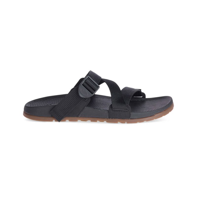 A CHACO LOWDOWN SLIDE WOVEN BLACK - MENS, by Chaco, with an adjustable buckle and strap. The sole is dark with a textured pattern and a light brown outer edge, offering arch-support for comfort. This lightweight sport sandal is photographed on a plain white background.