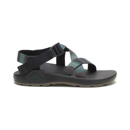 A CHACO Z CLOUD SANDAL WEAVE BLACK - MENS with adjustable black and teal straps, a black footbed, and a tan ChacoGrip rubber outsole for superior traction. Perfectly customize the fit for all-day comfort. Chaco's Classic Z Sandals combine both style and functionality.