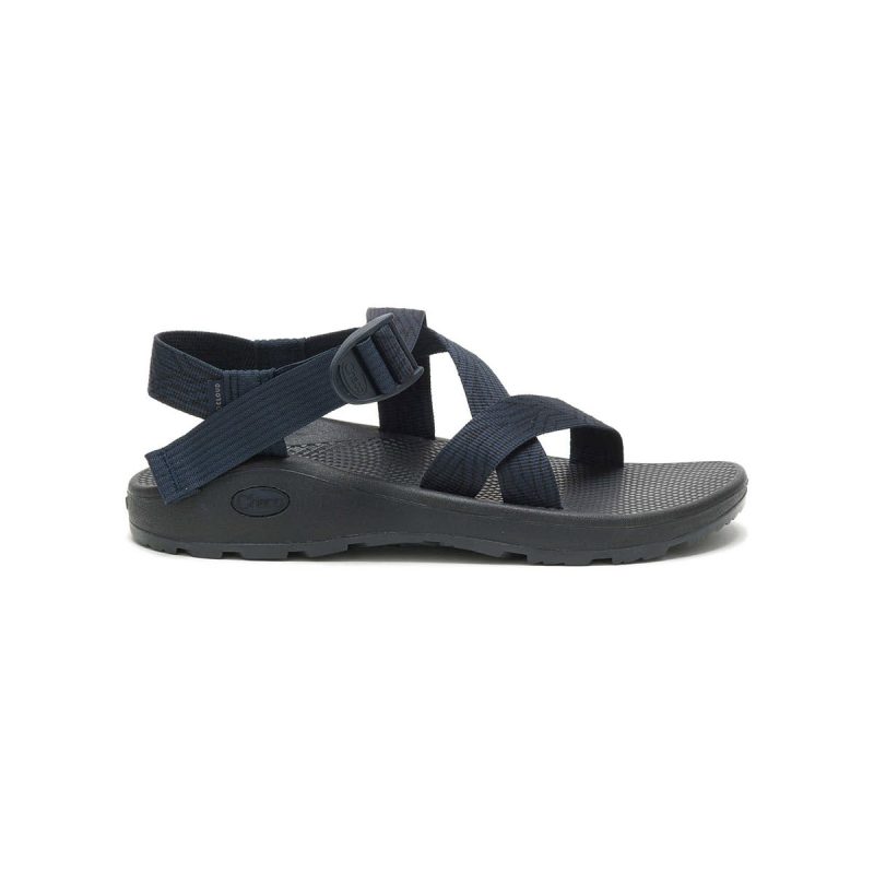 A single black sandal from the Z CLOUD SANDAL SERPENT NAVY - MENS series by Chaco with adjustable straps and a textured ChacoGrip™ sole, viewed from the side on a plain white background.